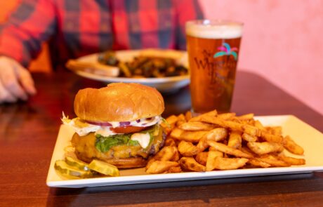 Buger in paradise with a side of fries and a beer