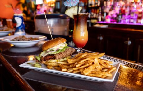 Burger in Paradise with fries and a tropical drink