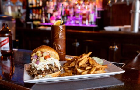 Sandwhich and fries on the bar at the Whistling Bird