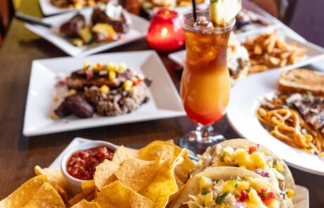 A variey of Caribbean dishes and tropical drinks on the table